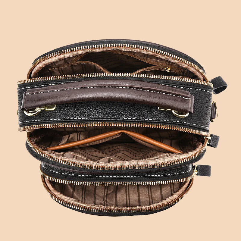 Bolso clásico multifuncional con compartimentos ajustables y correa ancha para el hombro.