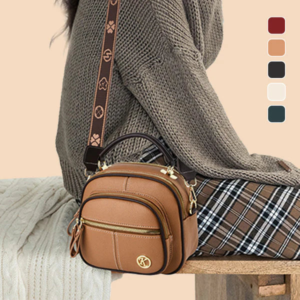 Bolso clásico multifuncional con compartimentos ajustables y correa ancha para el hombro.