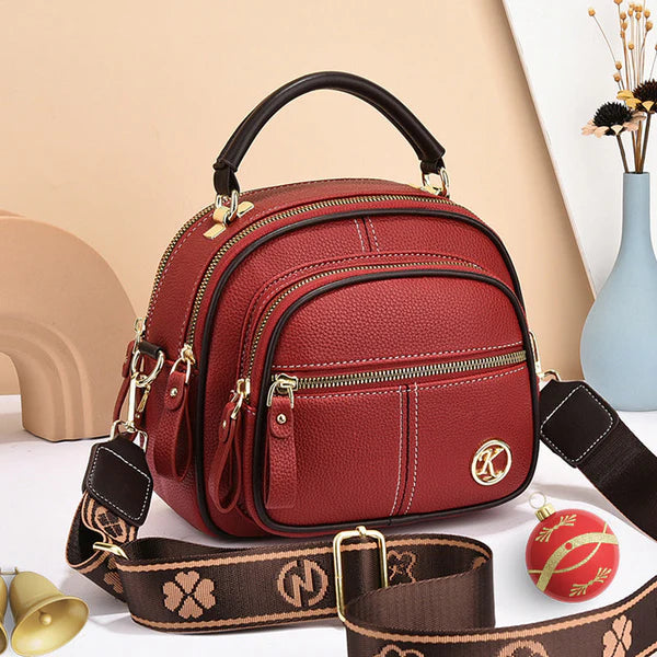 Bolso clásico multifuncional con compartimentos ajustables y correa ancha para el hombro.